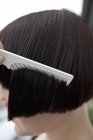 Вид збоку жінки розчісує вологе волосся — стокове фото