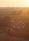 Elevated view of farmhouse in golden sunset light — Stock Photo
