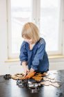 Girl making cookies, differential focus — Stock Photo