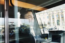 Female tram driver seen through window — Stock Photo