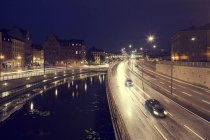 View of canal and bridge with moving cars at night — Stock Photo