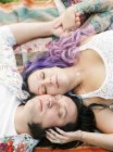 Bride and groom lying down at hippie wedding — Stock Photo