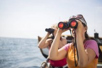 Turistas mirando a través de prismáticos, se centran en primer plano - foto de stock
