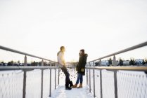 Young couple standing face to face on footbridge, selective focus — Stock Photo