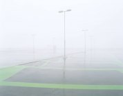 Empty parking lot covered in fog — Stock Photo