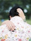 Bride and groom in shirt with floral pattern at hippie wedding, selective focus — Stock Photo
