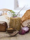 Jar with mustard pickled herring, rye bread and crispbread — Stock Photo