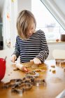 Girl making cookies, differential focus — Stock Photo