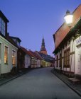 Old town street illuminated at night — Stock Photo