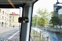 Reflection of female tram driver in rear view mirror — Stock Photo