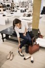 Woman trying on shoes in store, selective focus — Stock Photo