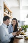 Couple during breakfast, focus on background — Stock Photo