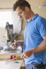 Carpenter using phone in workshop, focus on foreground — Stock Photo