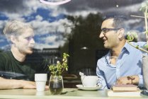 Portrait of two mid adult men in cafe — Stock Photo