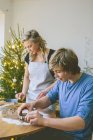 Couple preparing christmas cookies, selective focus — Stock Photo