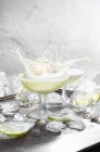 Still life with ice cream ball splashing in cocktail — Stock Photo