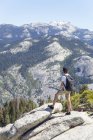 Boy looking at view with Sentinel Dome and Yosemite Falls — Stock Photo