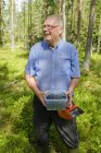 Senior man holding bucket with blueberries — Stock Photo