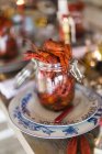 Jar with fresh boiled crayfish served on plates — Stock Photo