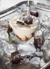 Cream splashing in glass of ice coffee cocktail — Stock Photo