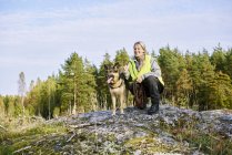 Portrait of volunteer with dog helping emergency services find missing people — Stock Photo