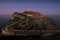 Lighthouse on edge of cliff at dusk, Cap Formentor, Spain — Stock Photo