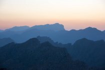 Rocky mountains silhouettes on sunset sky — Stock Photo