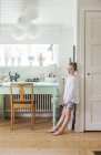 Girl leaning on wall in domestic room — Stock Photo