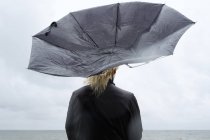 Frau unter schwarzem Regenschirm beobachtet Ostsee — Stockfoto
