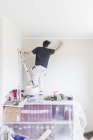 Rear view of mature man painting wall — Stock Photo