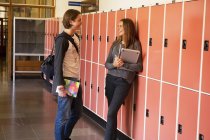 Вид збоку студентів, що говорять по шкільному коридору — стокове фото