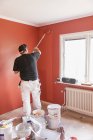 Rear view of mature man painting wall — Stock Photo