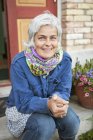 Portrait of mature woman in back yard — Stock Photo