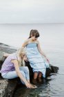 Two girls playing at seaside, focus on foreground — Stock Photo