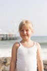 Portrait of blonde girl at seaside, selective focus — Stock Photo