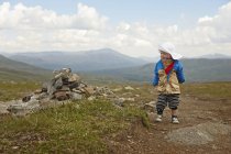 Boy standing in meadow, selective focus — Stock Photo