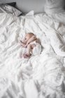 Newborn baby boy lying on bed, differential focus — Stock Photo