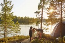 Family camping by river, selective focus — Stock Photo