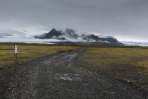 Gravel road under storm clouds in Iceland — Stock Photo