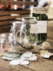 Glass jars on wooden background, selective focus — Stock Photo