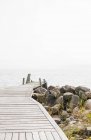View of jetty at misty lake, stockholm archipelago — Stock Photo