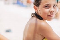 Girl in swimwear looking at camera, focus on foreground — Stock Photo