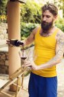 Bearded man pouring wine, focus on foreground — Stock Photo