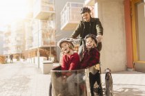 Man cycling with sons, selective focus — Stock Photo
