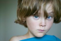 Portrait of boy with blue eyes, soft focus background — Stock Photo