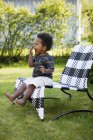 Boy sitting in lounge chair, selective focus — Stock Photo