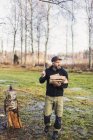 Man with firewood outdoors, selective focus — Stock Photo