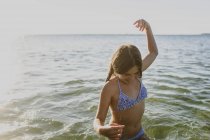 Молода дівчина, купання в морі, зосередити увагу на передньому плані — стокове фото