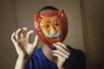 Portrait of man with animal mask, focus on foreground — Stock Photo