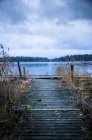 Wooden pier and lake, diminishing perspective — Stock Photo